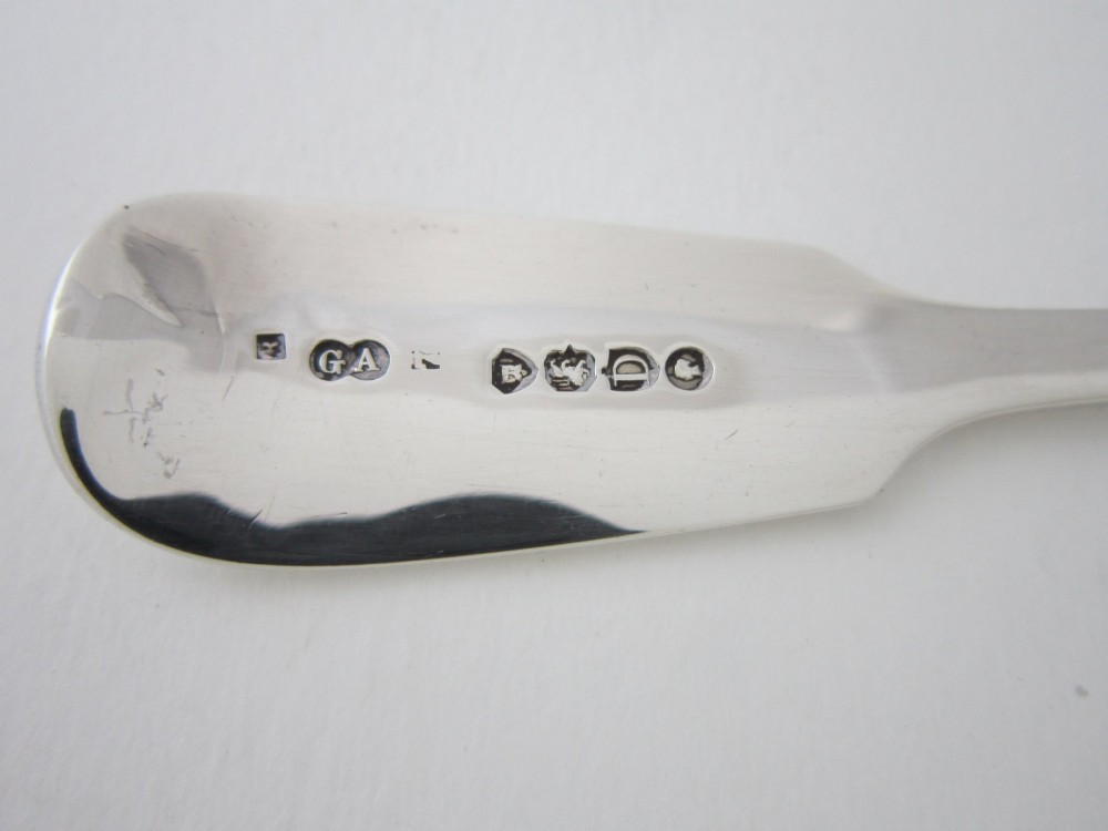 An antique Victorian sterling silver butter knife featuring a classic Fiddle pattern handle and a shaped spreading blade. View VII