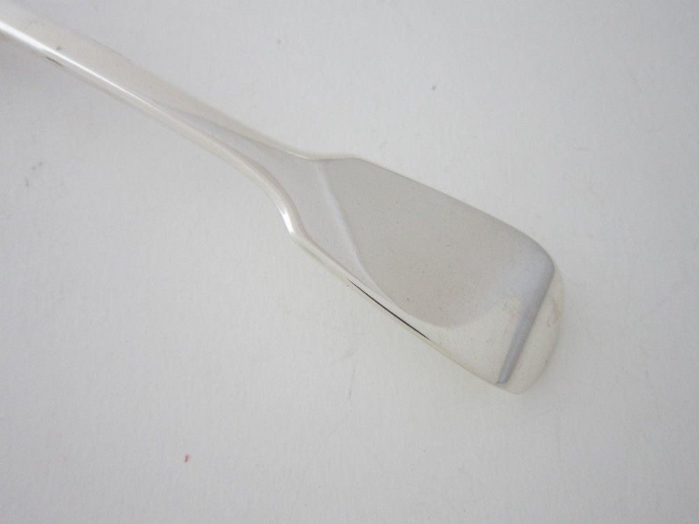 A Victorian sterling silver sauce ladle featuring a fiddle pattern handle and a round deep bowl, displayed on a plain white surface. View III