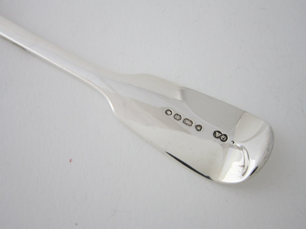 A Victorian sterling silver sauce ladle featuring a fiddle pattern handle and a round deep bowl, displayed on a plain white surface. View VI