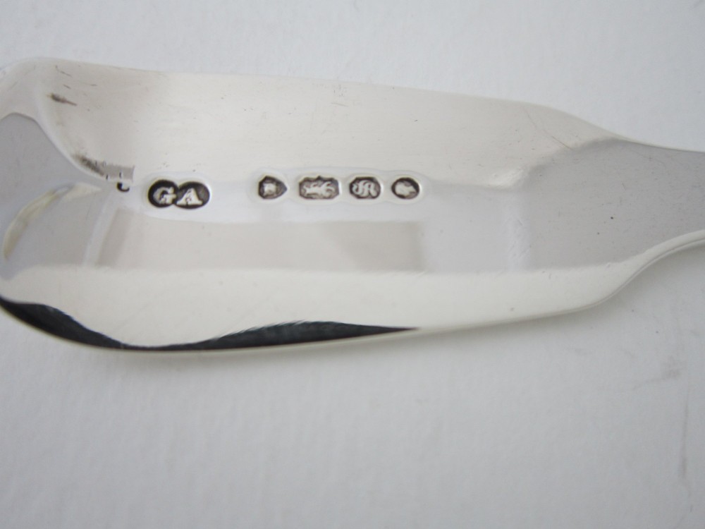A Victorian sterling silver sauce ladle featuring a fiddle pattern handle and a round deep bowl, displayed on a plain white surface. View VII