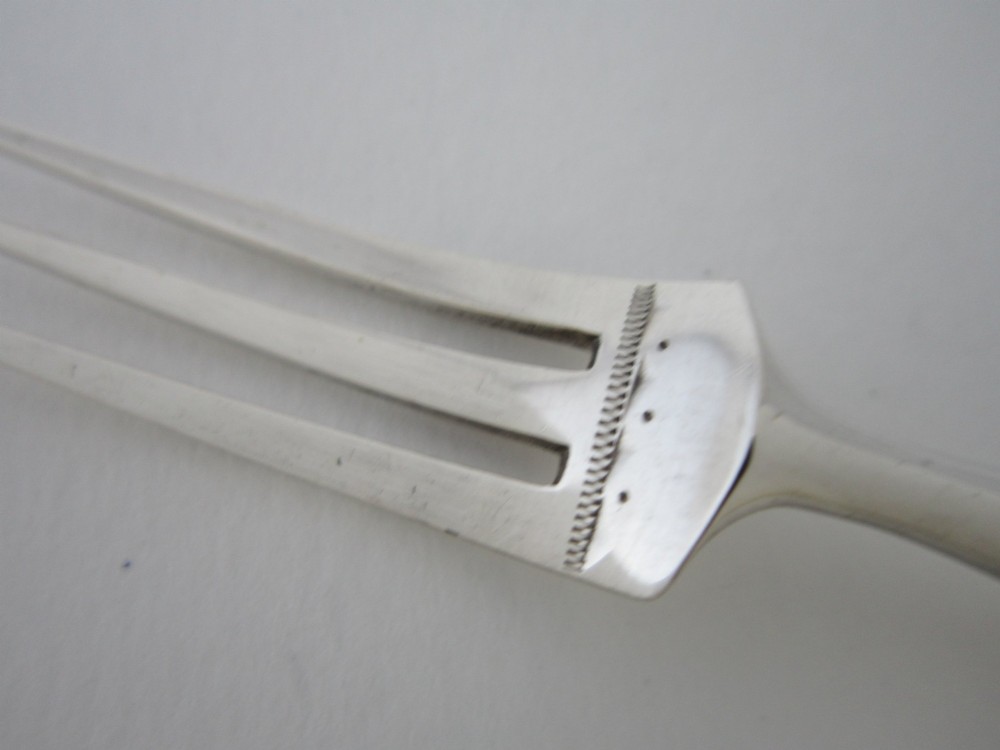 An open fitted wooden canteen displaying a set of sterling silver dessert knives and forks with mother-of-pearl handles set against a green velvet lining. View XI
