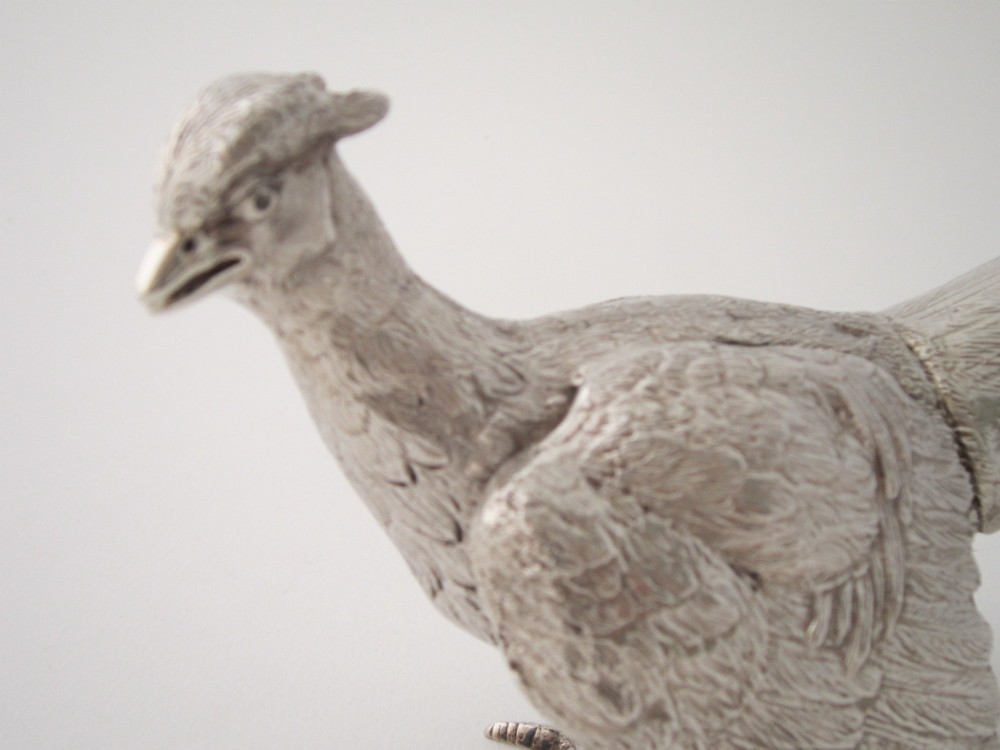 A pair of detailed cast sterling silver pheasants portrayed in naturalistic poses against a light background. View VI