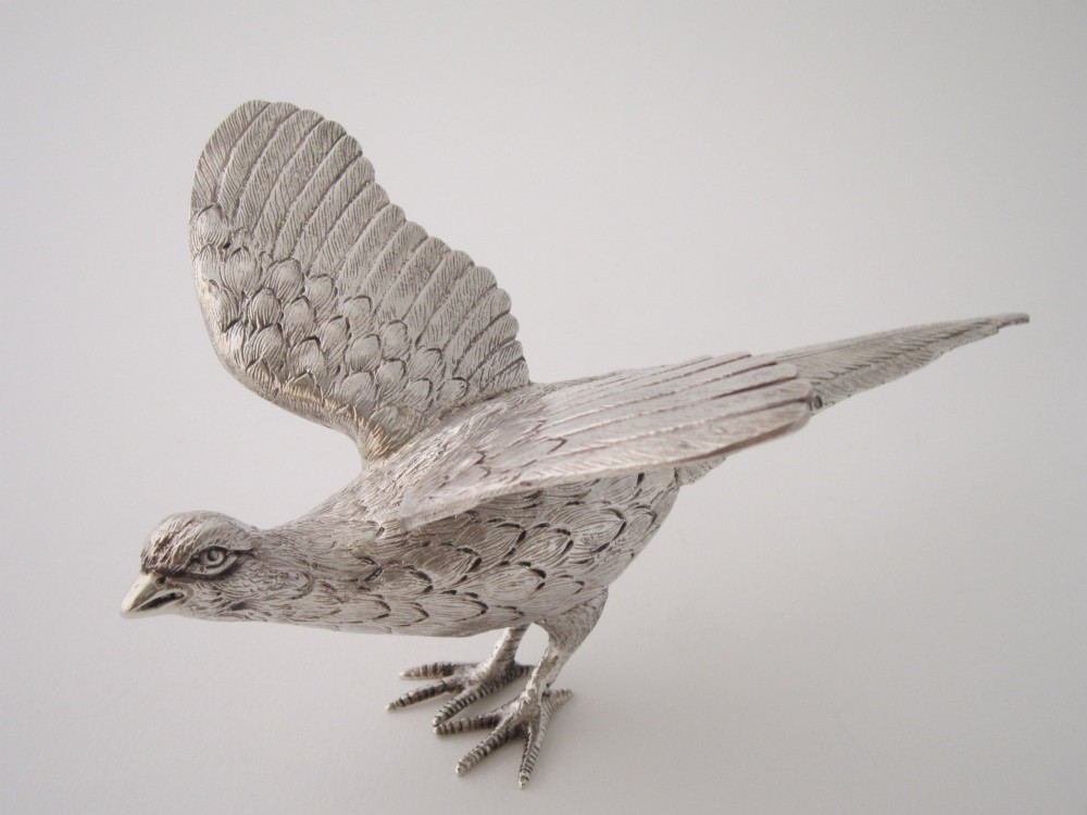 A pair of detailed cast sterling silver pheasants portrayed in naturalistic poses against a light background. View IX