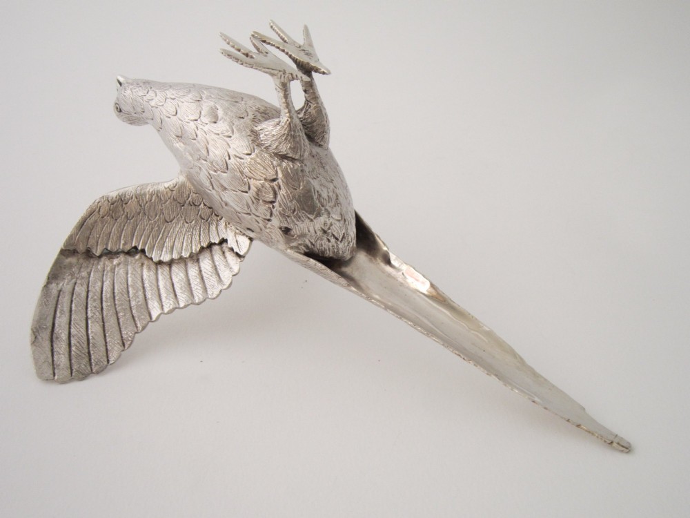 A pair of detailed cast sterling silver pheasants portrayed in naturalistic poses against a light background. View X