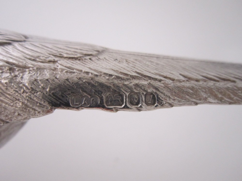 A pair of detailed cast sterling silver pheasants portrayed in naturalistic poses against a light background. View XII