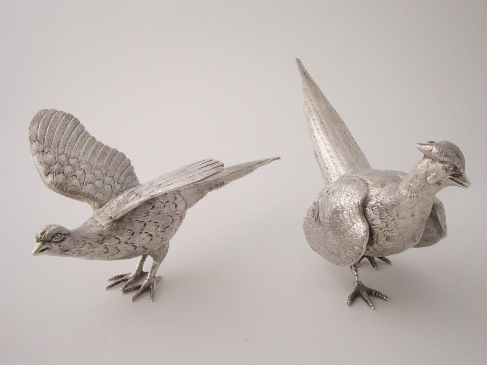 A pair of detailed cast sterling silver pheasants portrayed in naturalistic poses against a light background. View XIII