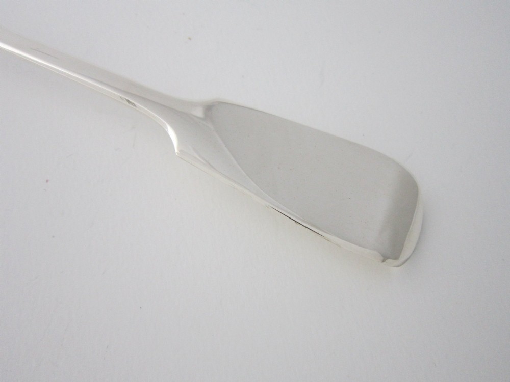 An antique Victorian sterling silver basting spoon featuring a fiddle pattern handle and polished oval bowl. View III