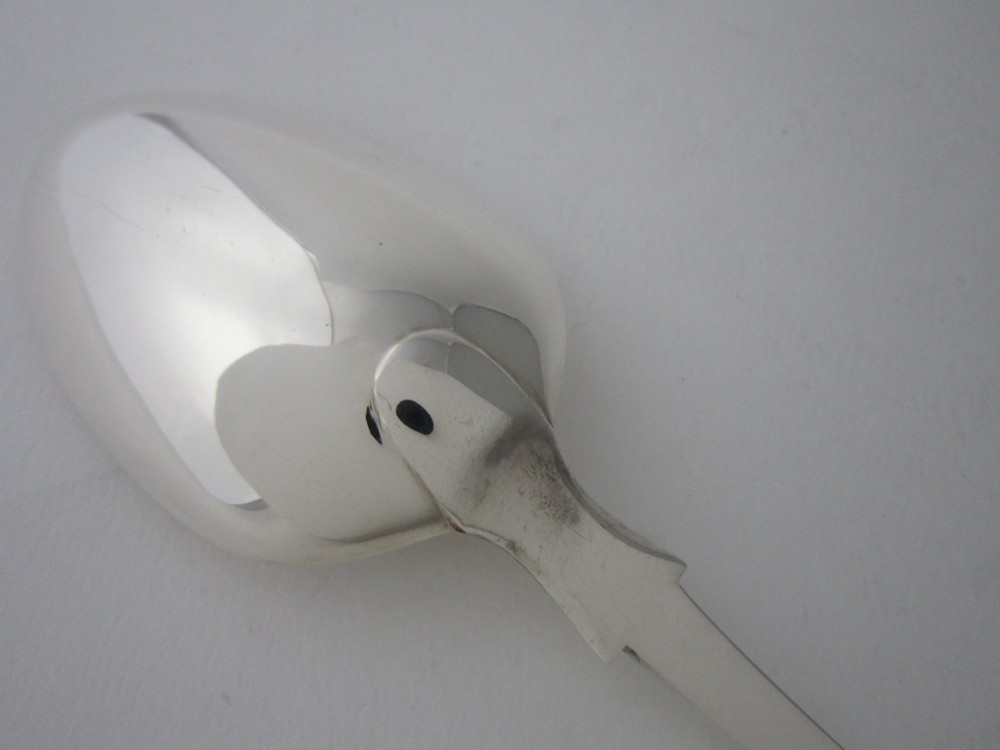 An antique Victorian sterling silver basting spoon featuring a fiddle pattern handle and polished oval bowl. View V