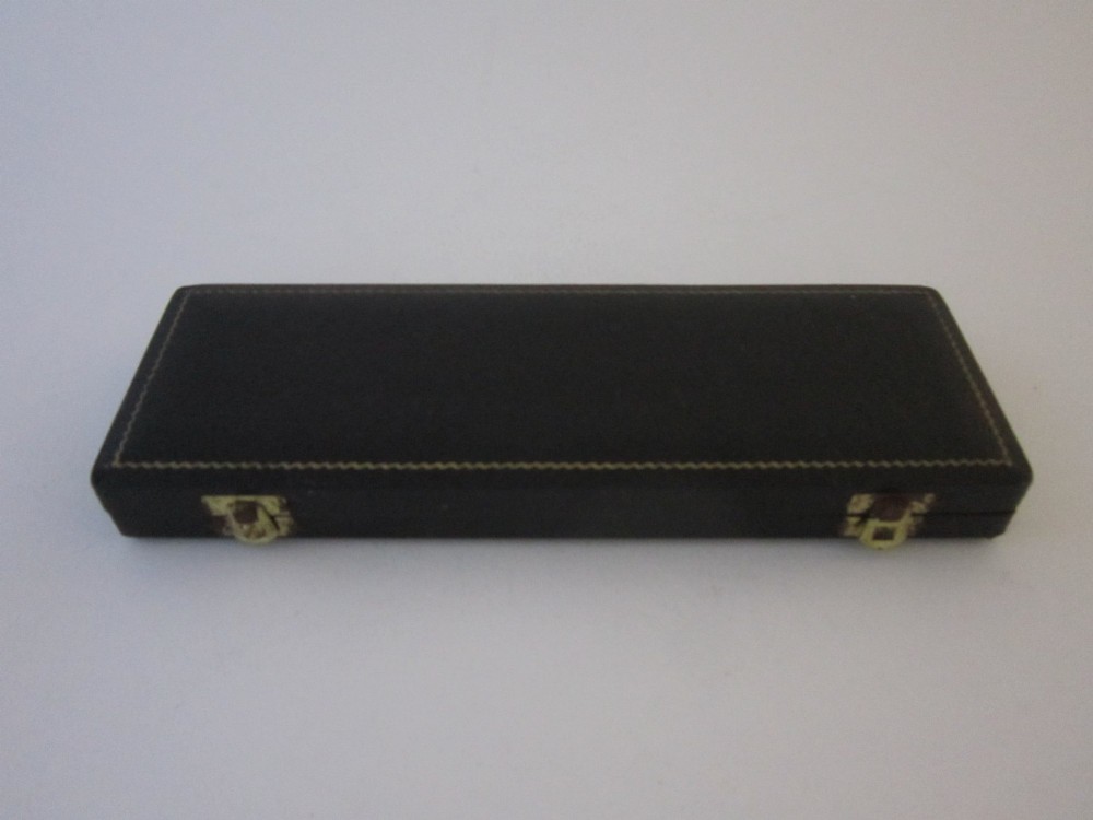 A pair of sterling silver lobster picks with embossed crustacean central medallions displayed inside a fitted black satin and velvet presentation box. View III