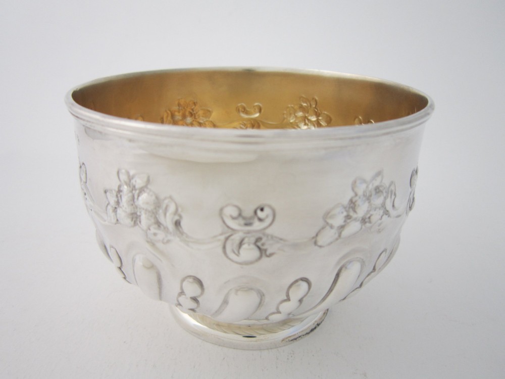 An Edwardian sterling silver bowl featuring embossed scrollwork decoration and a gilt interior. View III