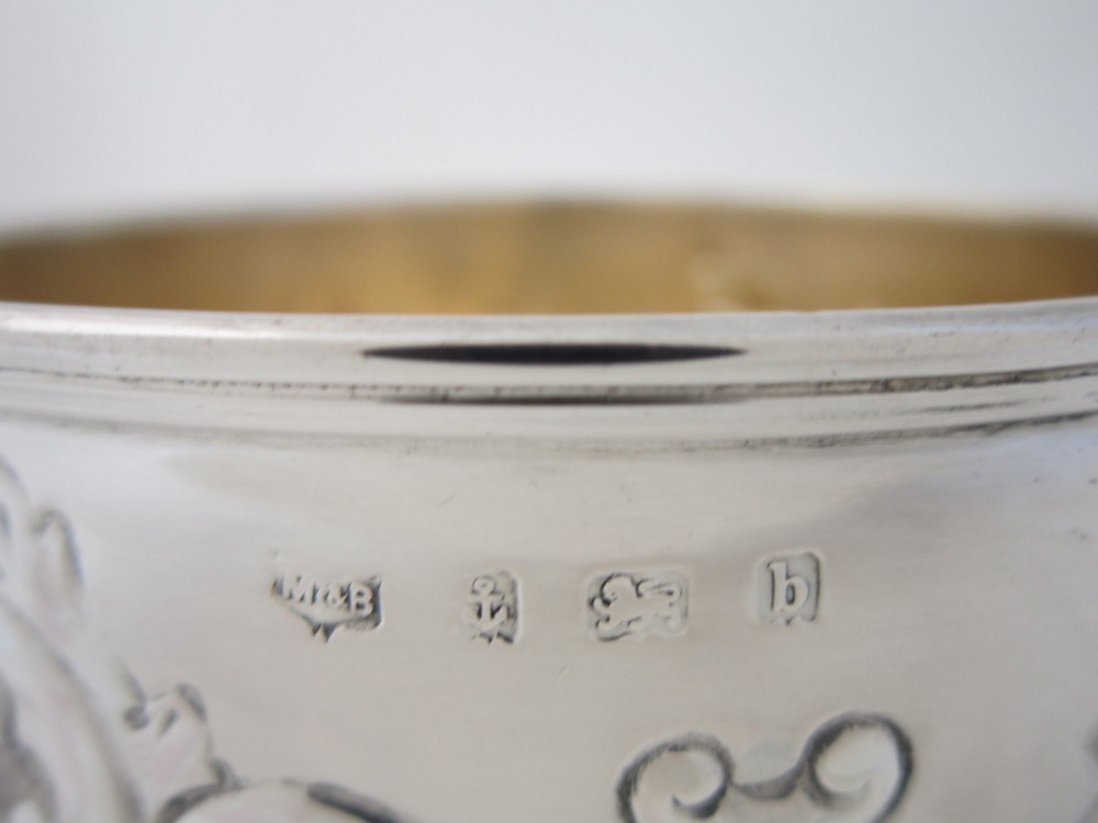 An Edwardian sterling silver bowl featuring embossed scrollwork decoration and a gilt interior. View VII