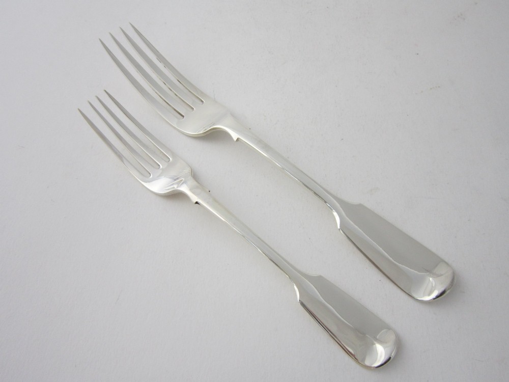An open oak cutlery canteen with double doors revealing three fitted drawers filled with sterling silver flatware and featuring brass campaign handles. View VI