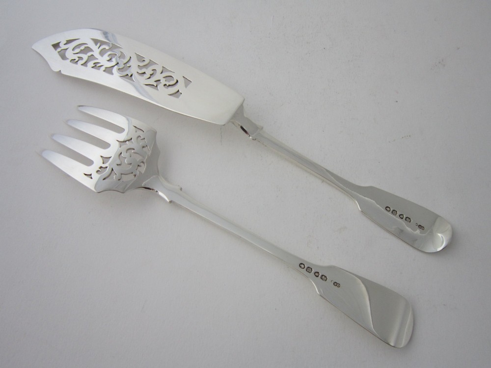 An open oak cutlery canteen with double doors revealing three fitted drawers filled with sterling silver flatware and featuring brass campaign handles. View XI