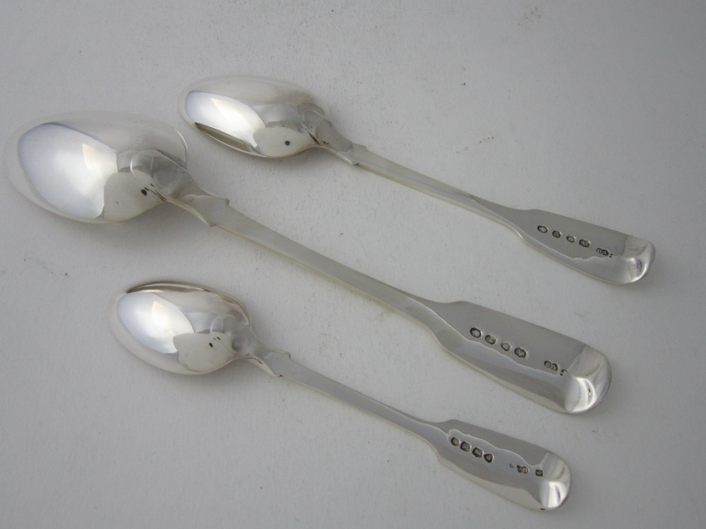 An open oak cutlery canteen with double doors revealing three fitted drawers filled with sterling silver flatware and featuring brass campaign handles. View XII