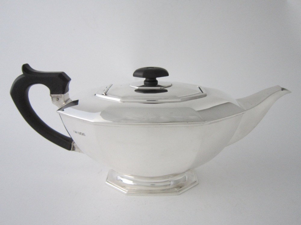 An octagonal sterling silver teapot featuring an ebonised wooden handle and matching black lid finial. View III