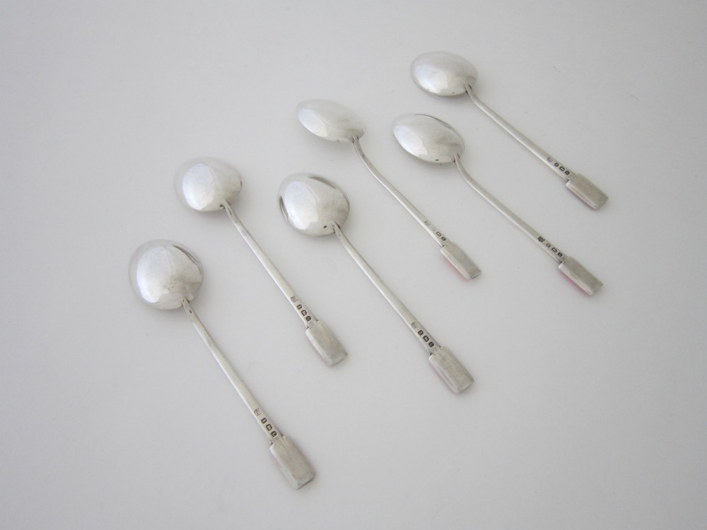 A set of six Art Deco sterling silver coffee spoons with pink enamelled terminals presented in an open blue silk and velvet lined case. View IV