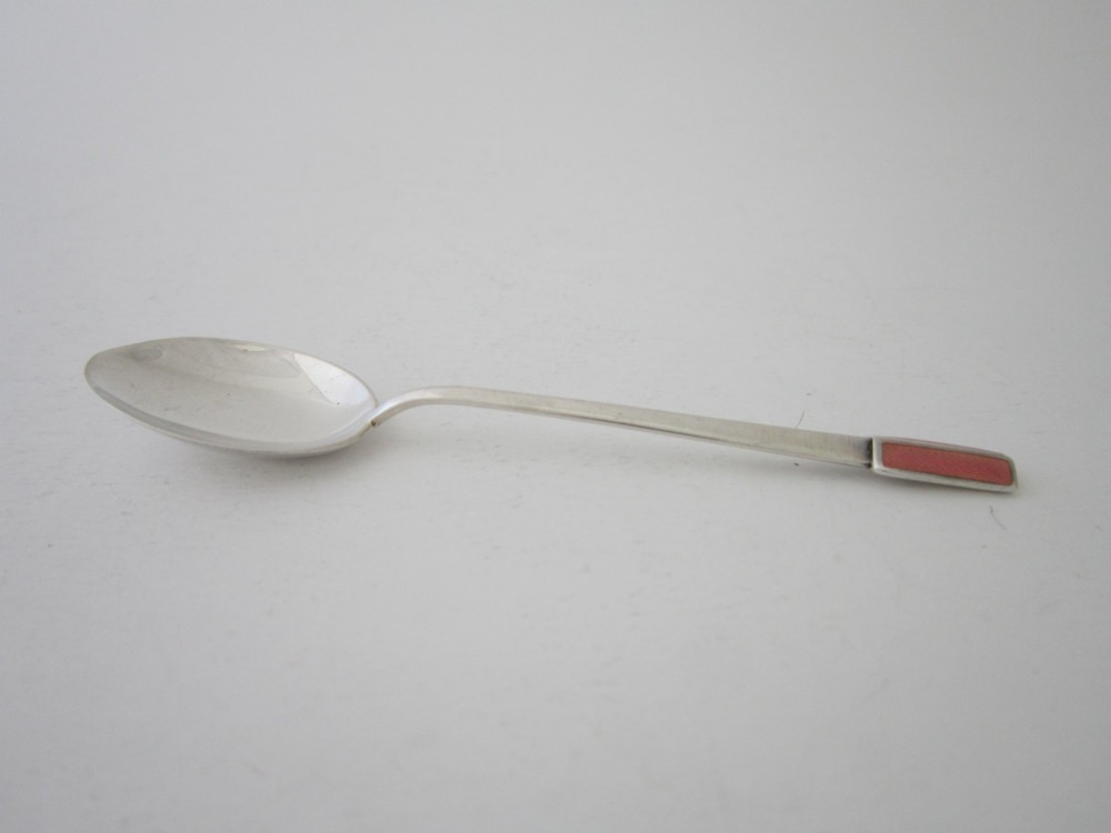 A set of six Art Deco sterling silver coffee spoons with pink enamelled terminals presented in an open blue silk and velvet lined case. View VI