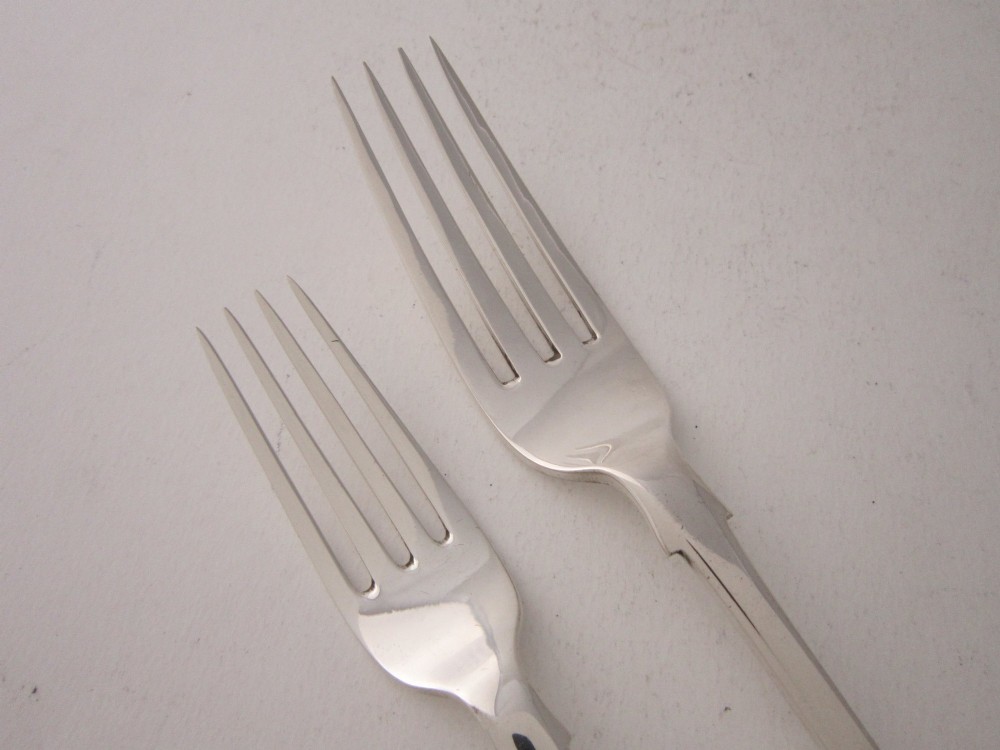 An open fitted wooden canteen displaying a multi-piece sterling silver cutlery set in fiddle pattern on blue velvet lining. View IX