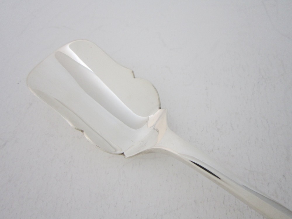 A sterling silver Stilton scoop featuring a curved rectangular shovel blade and a smooth Old English pattern handle. View II