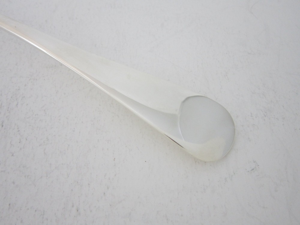 A sterling silver Stilton scoop featuring a curved rectangular shovel blade and a smooth Old English pattern handle. View III