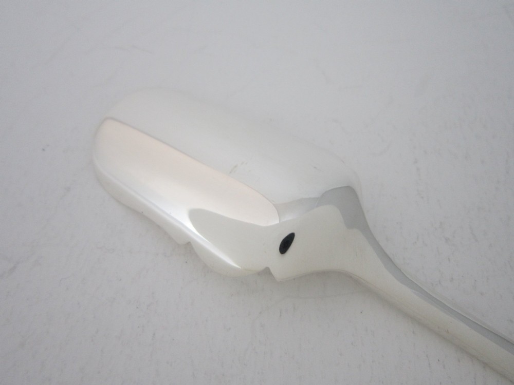 A sterling silver Stilton scoop featuring a curved rectangular shovel blade and a smooth Old English pattern handle. View V