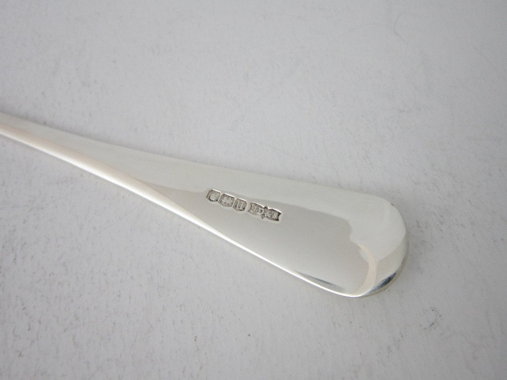 A sterling silver Stilton scoop featuring a curved rectangular shovel blade and a smooth Old English pattern handle. View VI