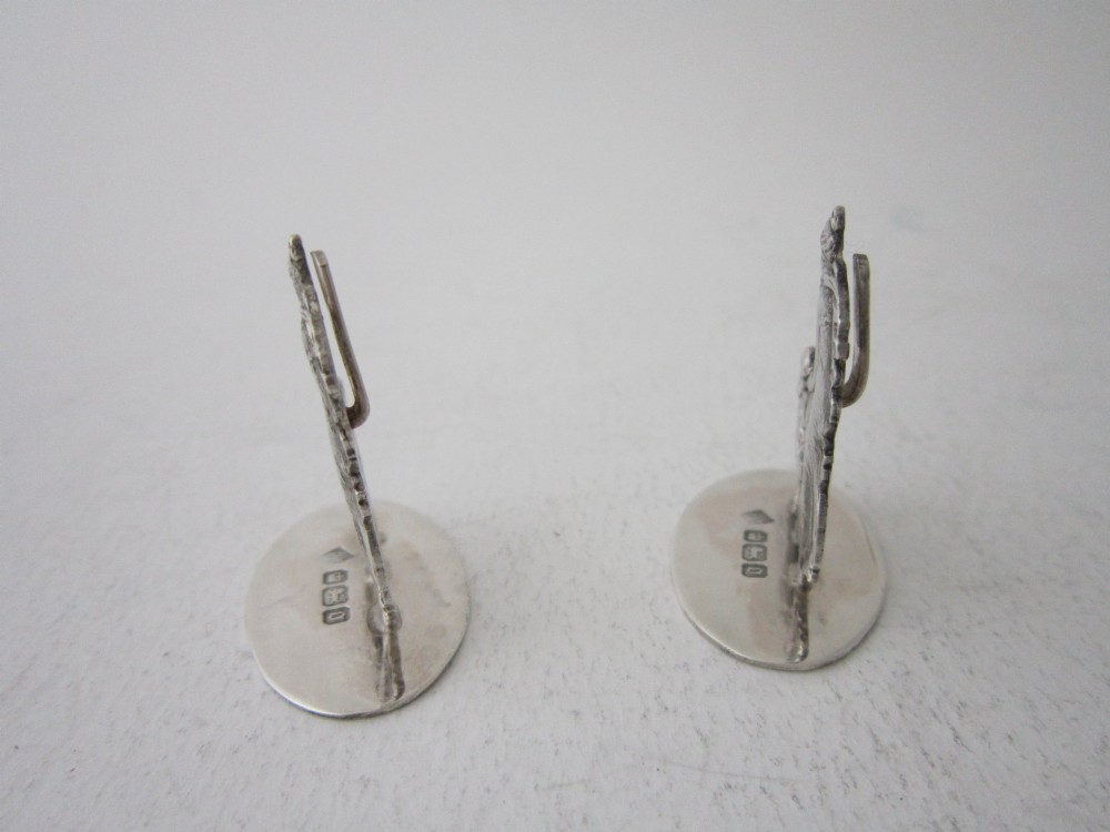 A pair of Edwardian sterling silver place card holders featuring classical female figures and cherubs on round hallmarked bases. View III