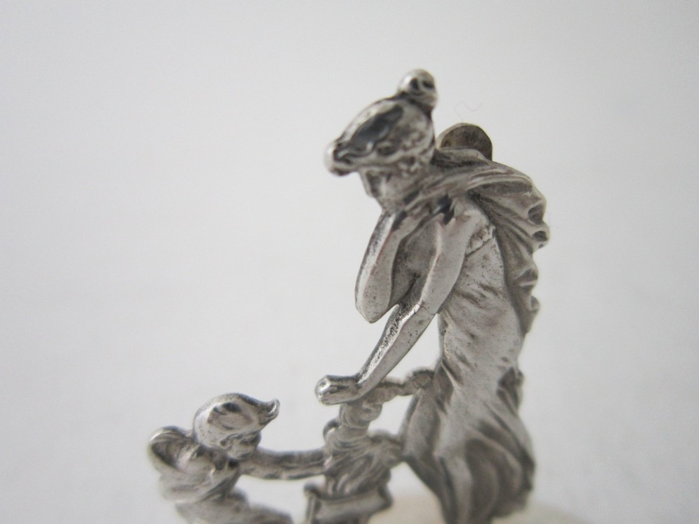 A pair of Edwardian sterling silver place card holders featuring classical female figures and cherubs on round hallmarked bases. View V