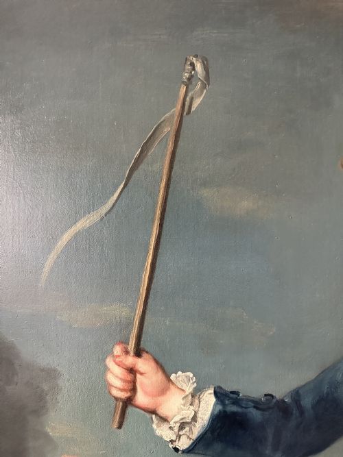 fig 4. An 18th-century full-length oil painting of a young boy in a blue coat holding a whip beside a spinning top, set within a carved gold frame.