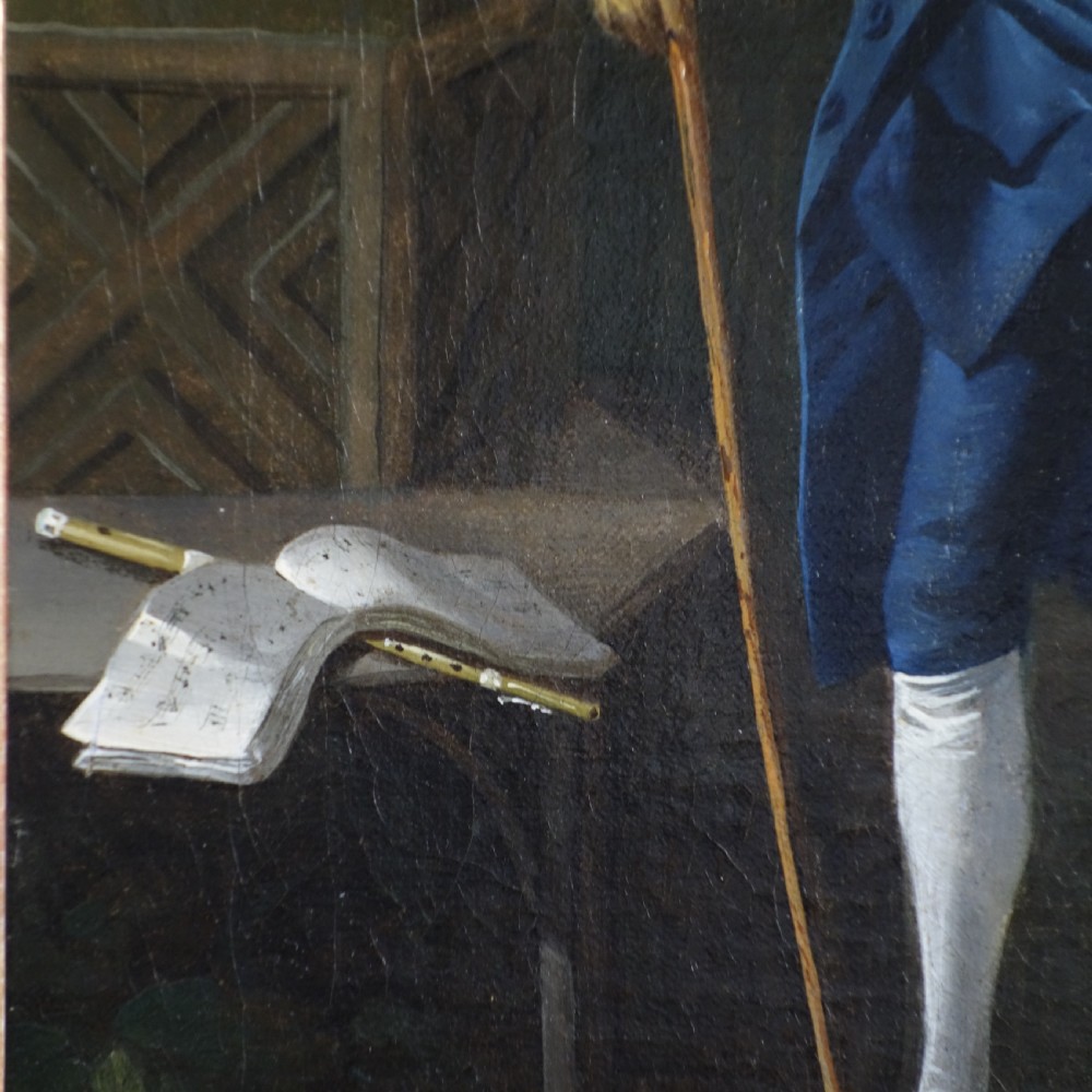 An 18th-century oil portrait of a gentleman wearing a blue frock coat and standing outdoors beside sheet music, displayed in a carved giltwood frame. View III