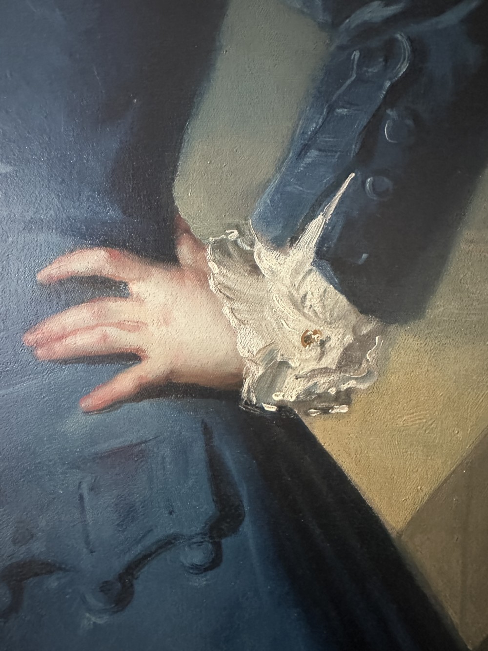 An 18th-century full-length oil painting of a young boy in a blue coat holding a whip beside a spinning top, set within a carved gold frame. View VII