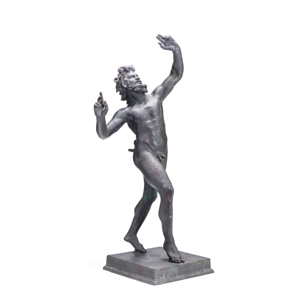 A nineteenth-century patinated bronze sculpture depicting the Dancing Faun of Pompeii with raised arms standing on a square base.