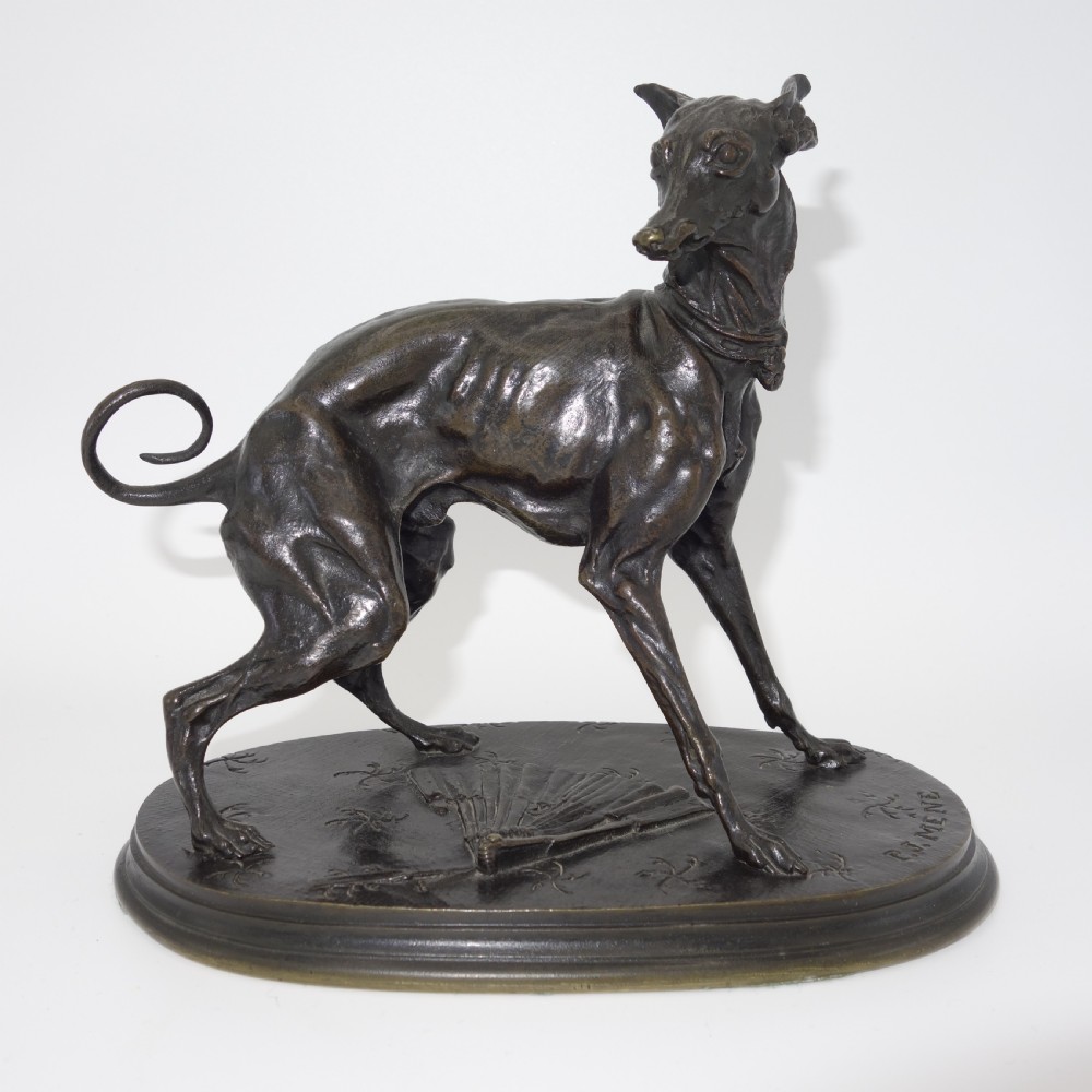 A dark brown patinated bronze sculpture of an Italian greyhound standing on an oval base decorated with a fan motif and signed P.J. Mene.