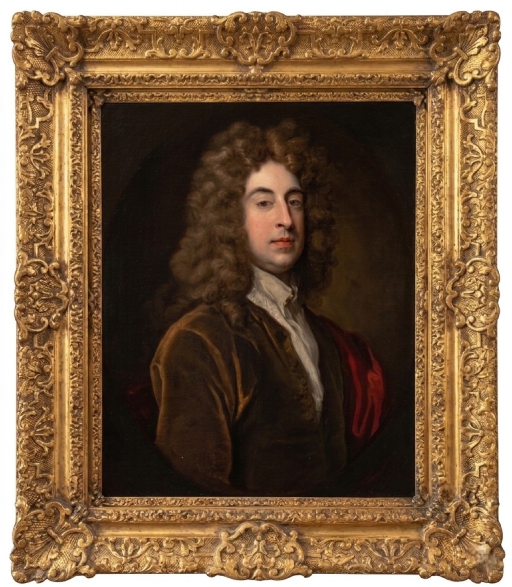 An oil painting of a gentleman with a long dark wig and brown velvet jacket set inside an ornate gilded frame.