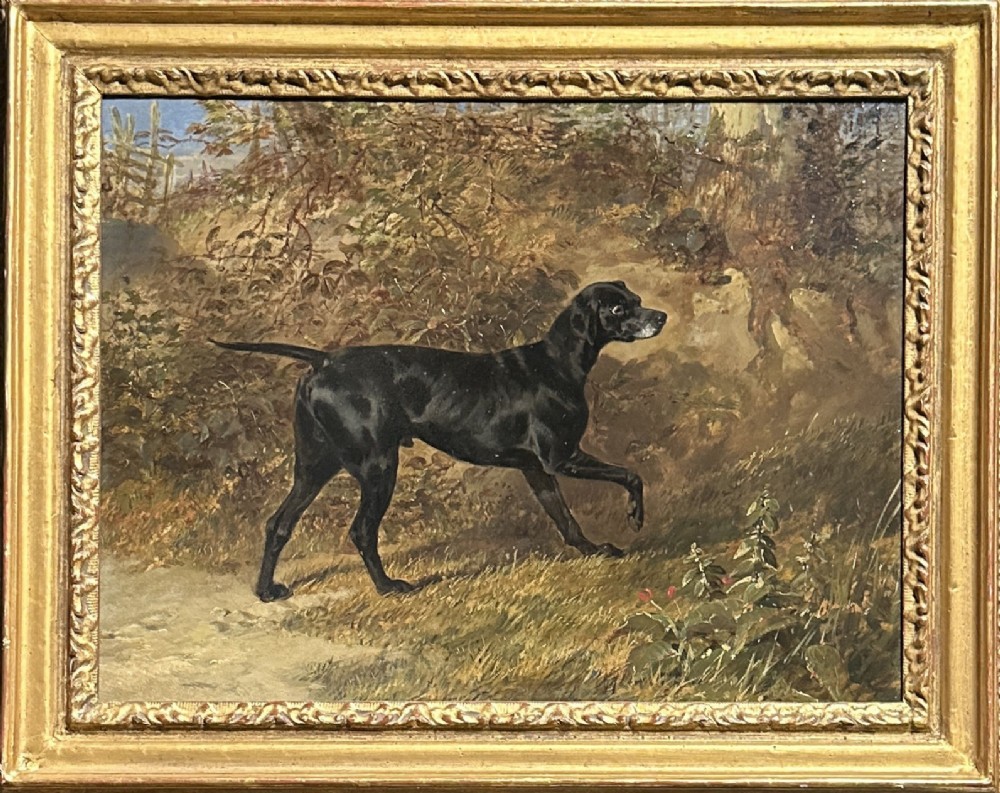 A 19th-century oil painting depicting a black pointer dog in profile against a landscape, set within a carved gilt wood frame.