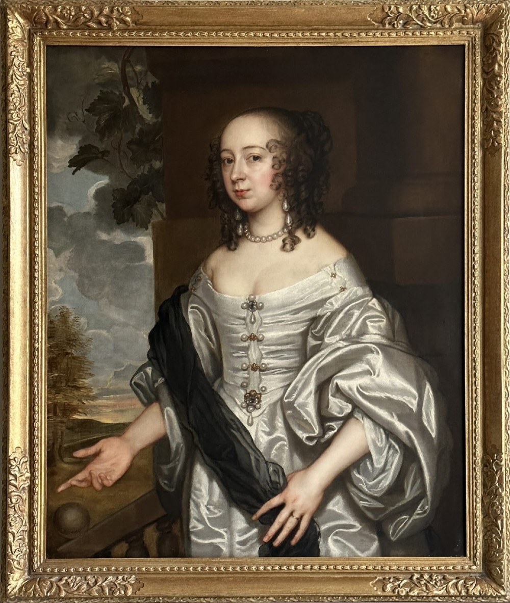 A 17th-century oil painting depicting a lady wearing a white satin gown and pearl jewellery set in a carved gold leaf frame.