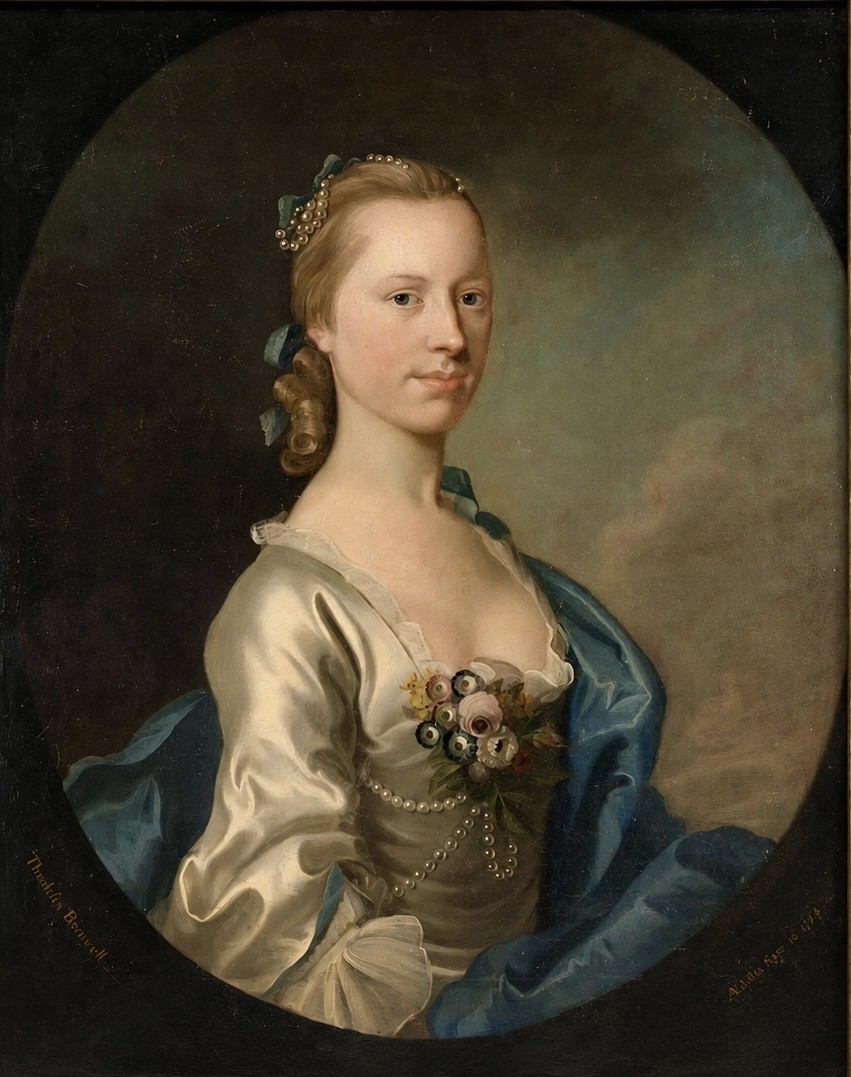 An 18th-century oil painting depicting a young lady in a white satin dress with a blue drape, set within an oval composition inside a heavily carved gold frame. View III