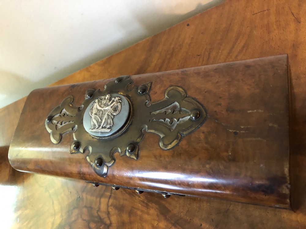 A rectangular Victorian burr walnut box featuring decorative brass strapwork and a central oval blue cameo plaque depicting classical figures. View III