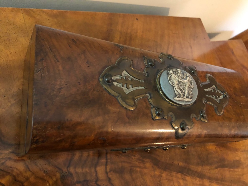 A rectangular Victorian burr walnut box featuring decorative brass strapwork and a central oval blue cameo plaque depicting classical figures. View VIII