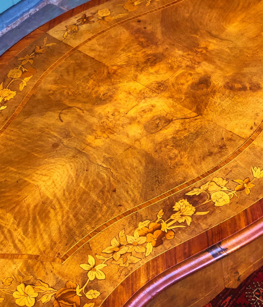 A 19th-century French Louis XV style inlaid writing desk featuring floral marquetry, a serpentine top, cabriole legs, and gilt-bronze mounts. View II