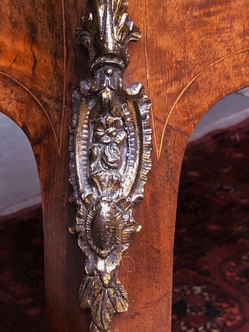 A 19th-century French Louis XV style inlaid writing desk featuring floral marquetry, a serpentine top, cabriole legs, and gilt-bronze mounts. View VI