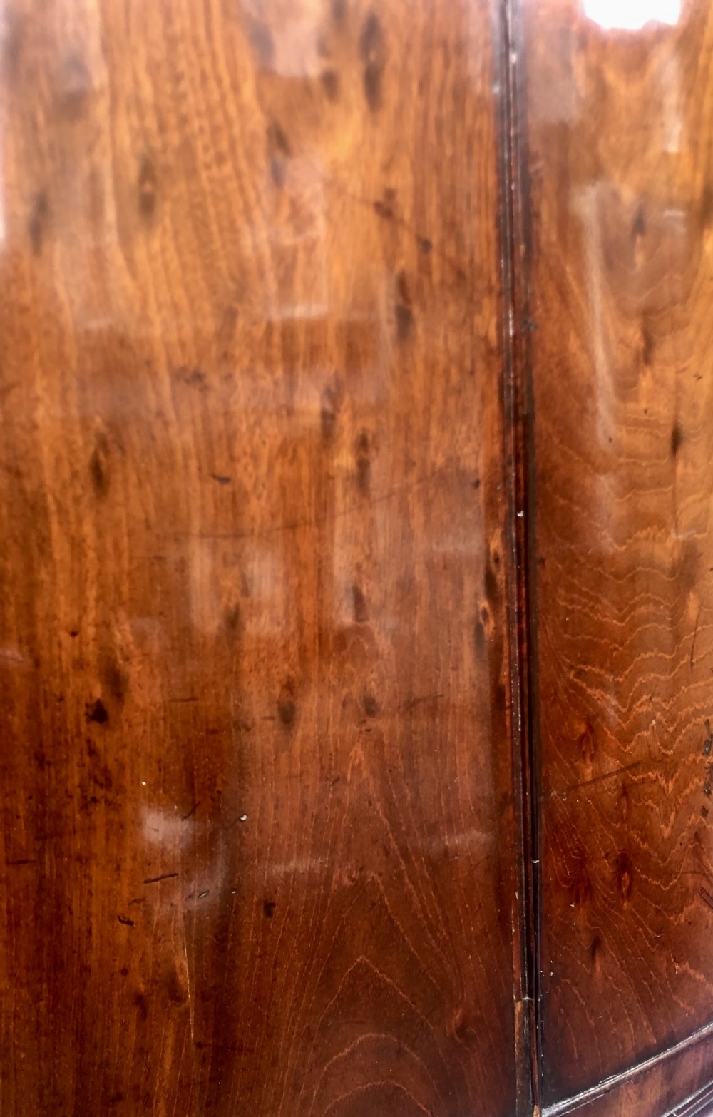 A Georgian bow-fronted mahogany corner cupboard with double doors, brass keyhole escutcheons, and visible brass hinges. View II