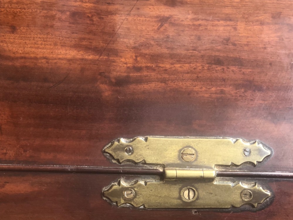 A Georgian bow-fronted mahogany corner cupboard with double doors, brass keyhole escutcheons, and visible brass hinges. View X
