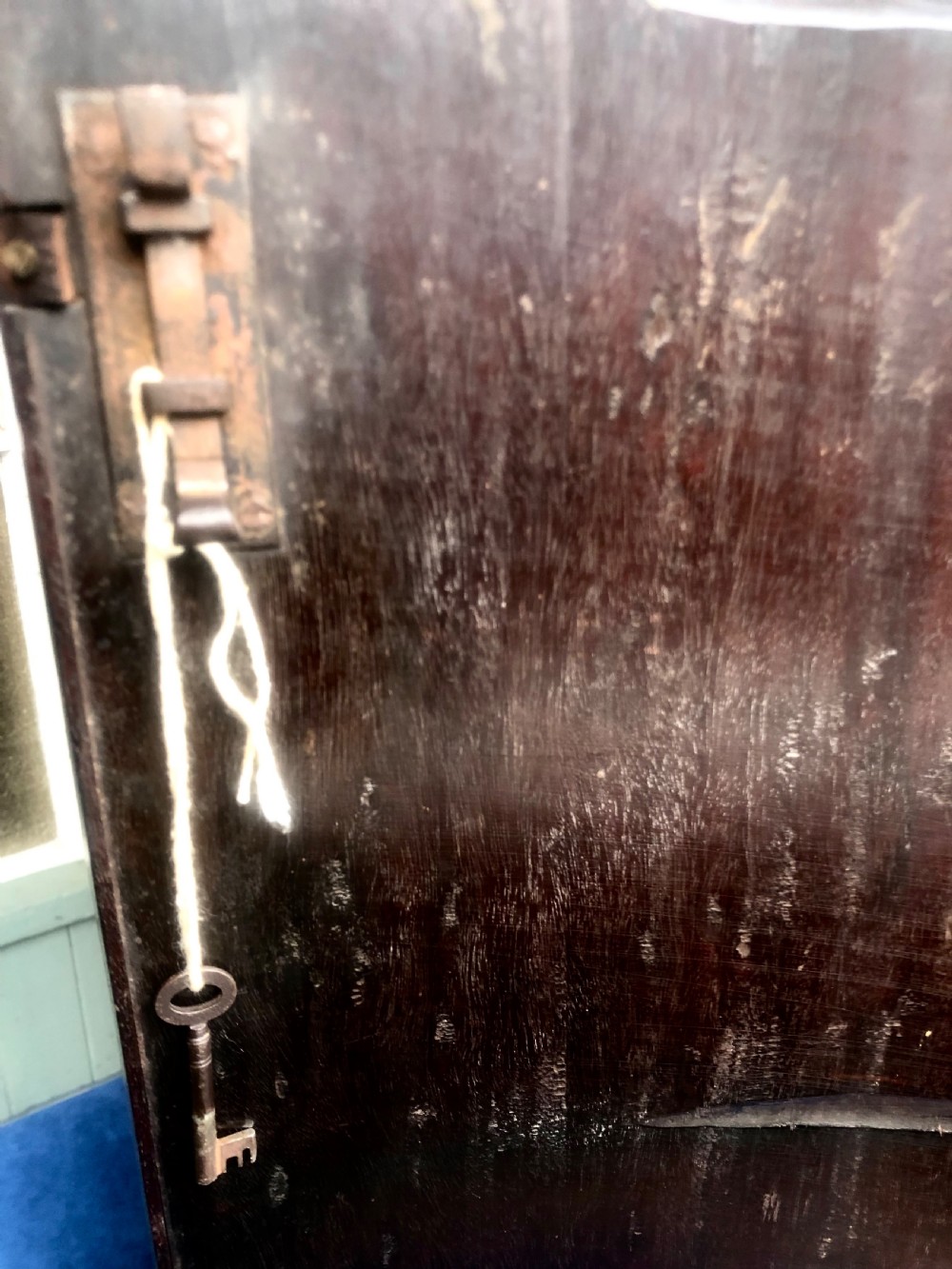 A Georgian bow-fronted mahogany corner cupboard with double doors, brass keyhole escutcheons, and visible brass hinges. View XI