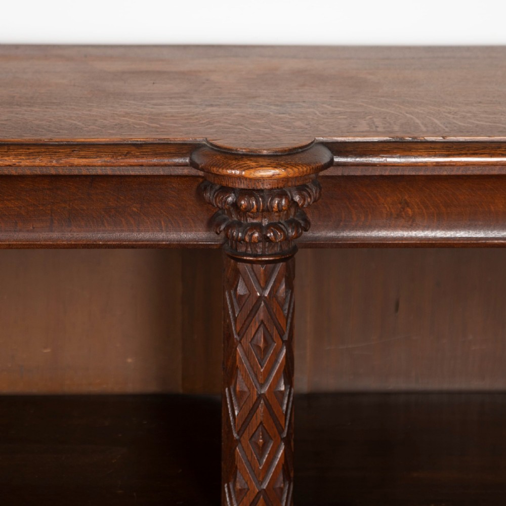 A pair of 19th-century dark wood low open bookcases featuring carved pilasters and open shelves. View V