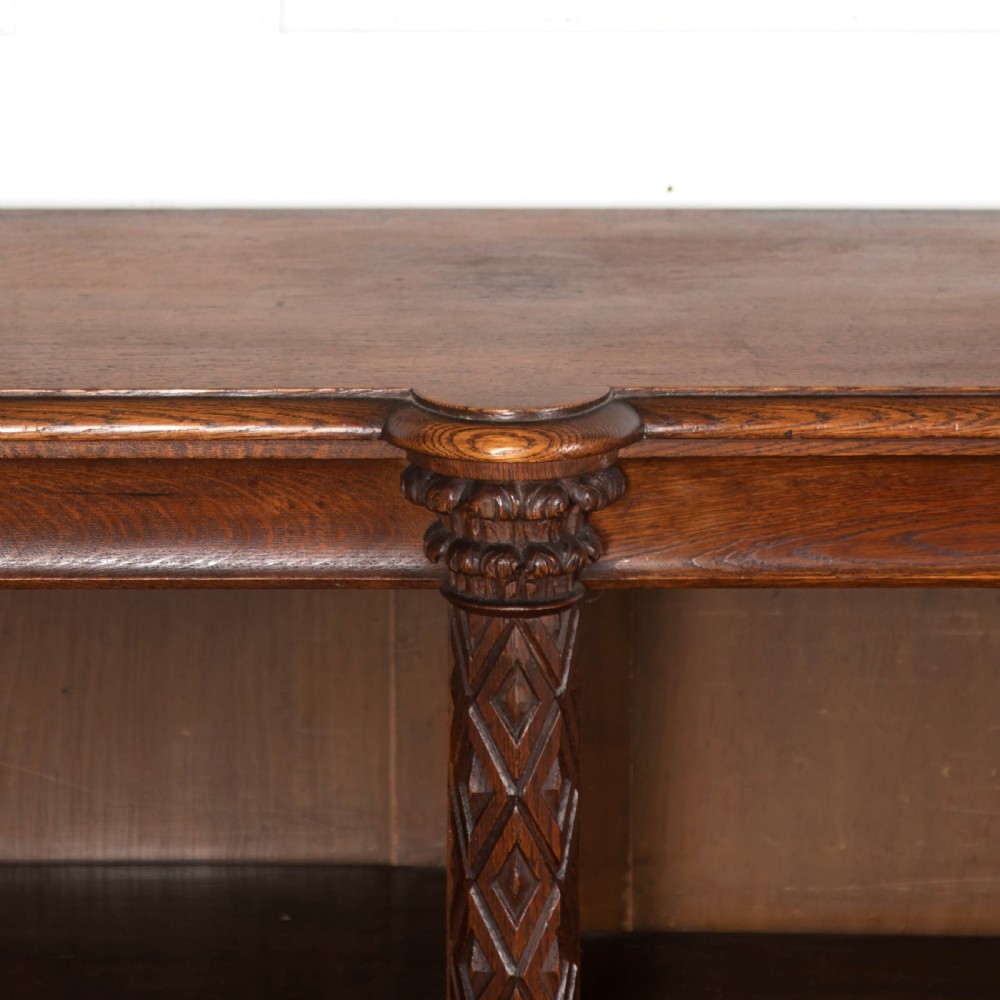A pair of 19th-century dark wood low open bookcases featuring carved pilasters and open shelves. View VI