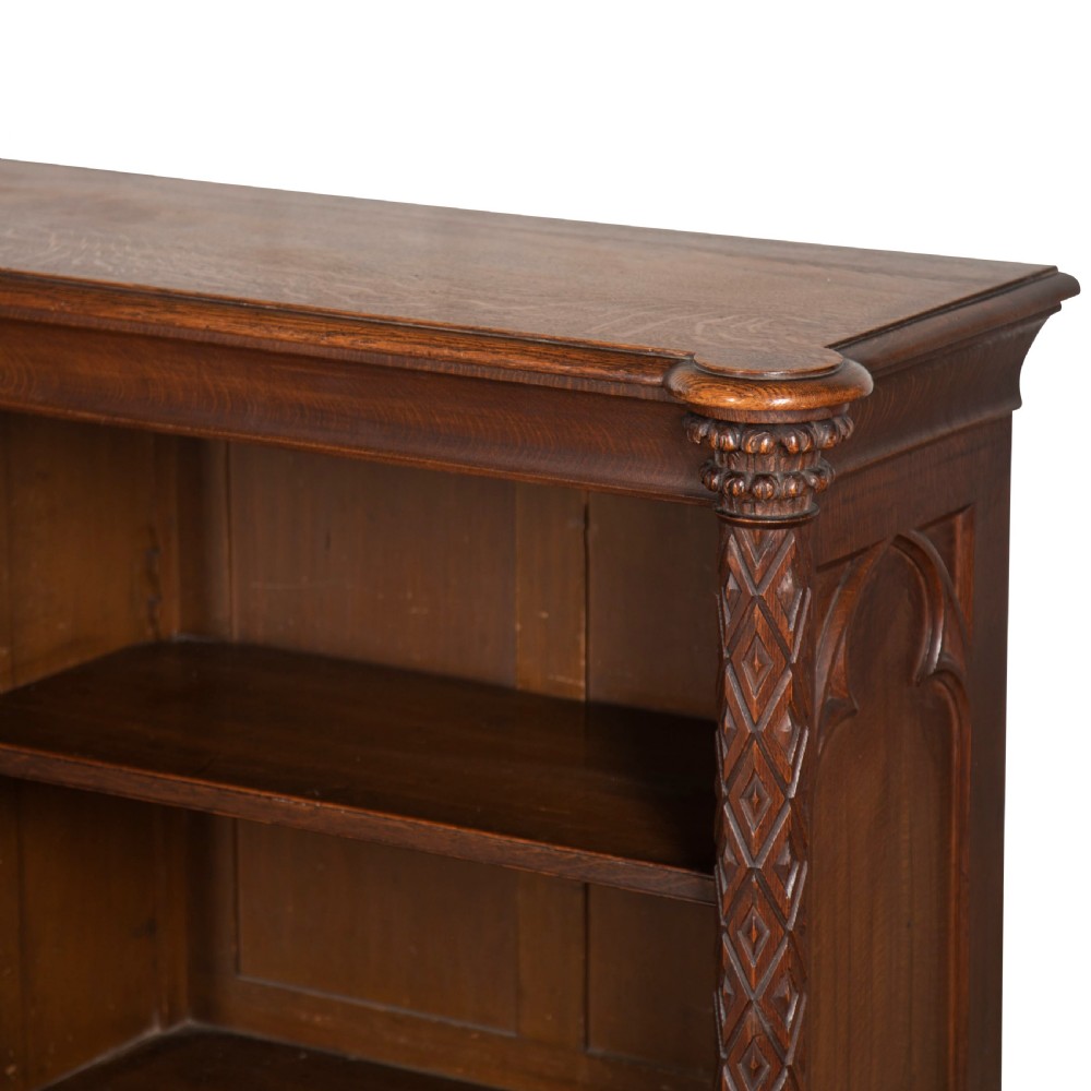 A pair of 19th-century dark wood low open bookcases featuring carved pilasters and open shelves. View VIII