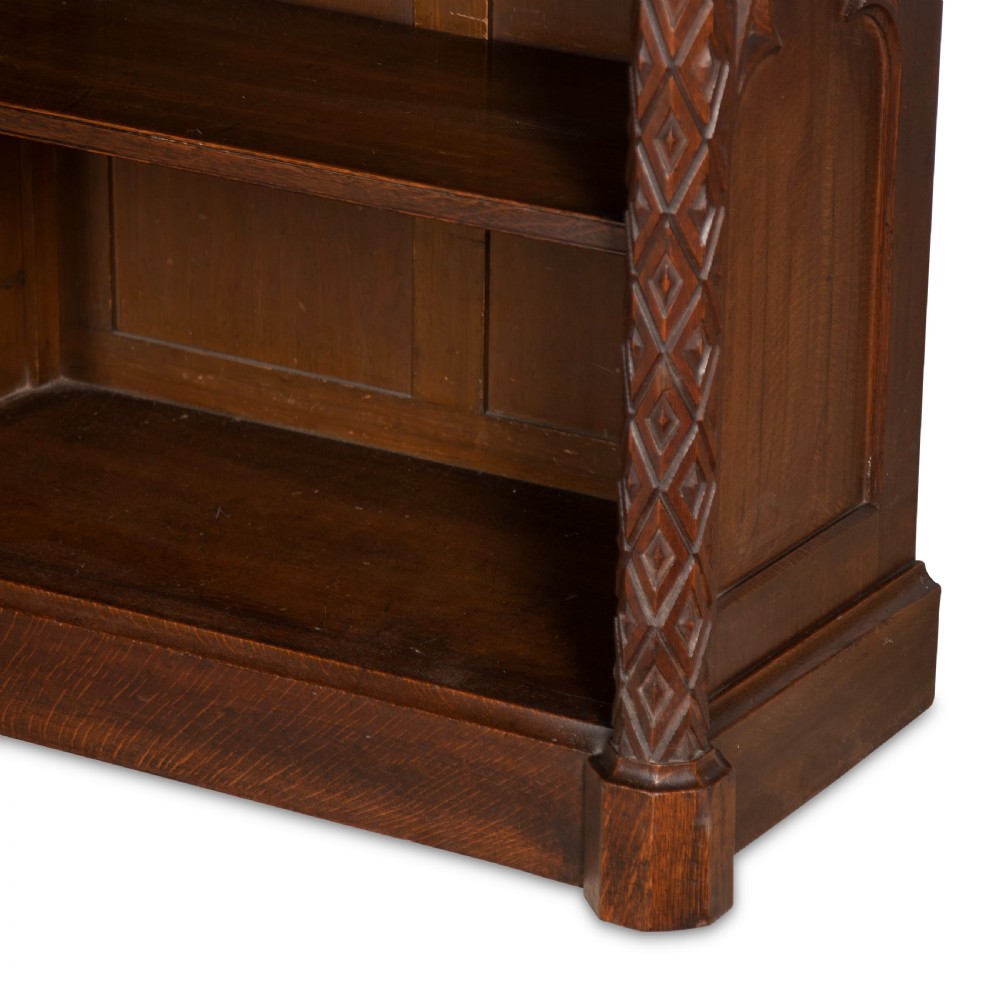 A pair of 19th-century dark wood low open bookcases featuring carved pilasters and open shelves. View X