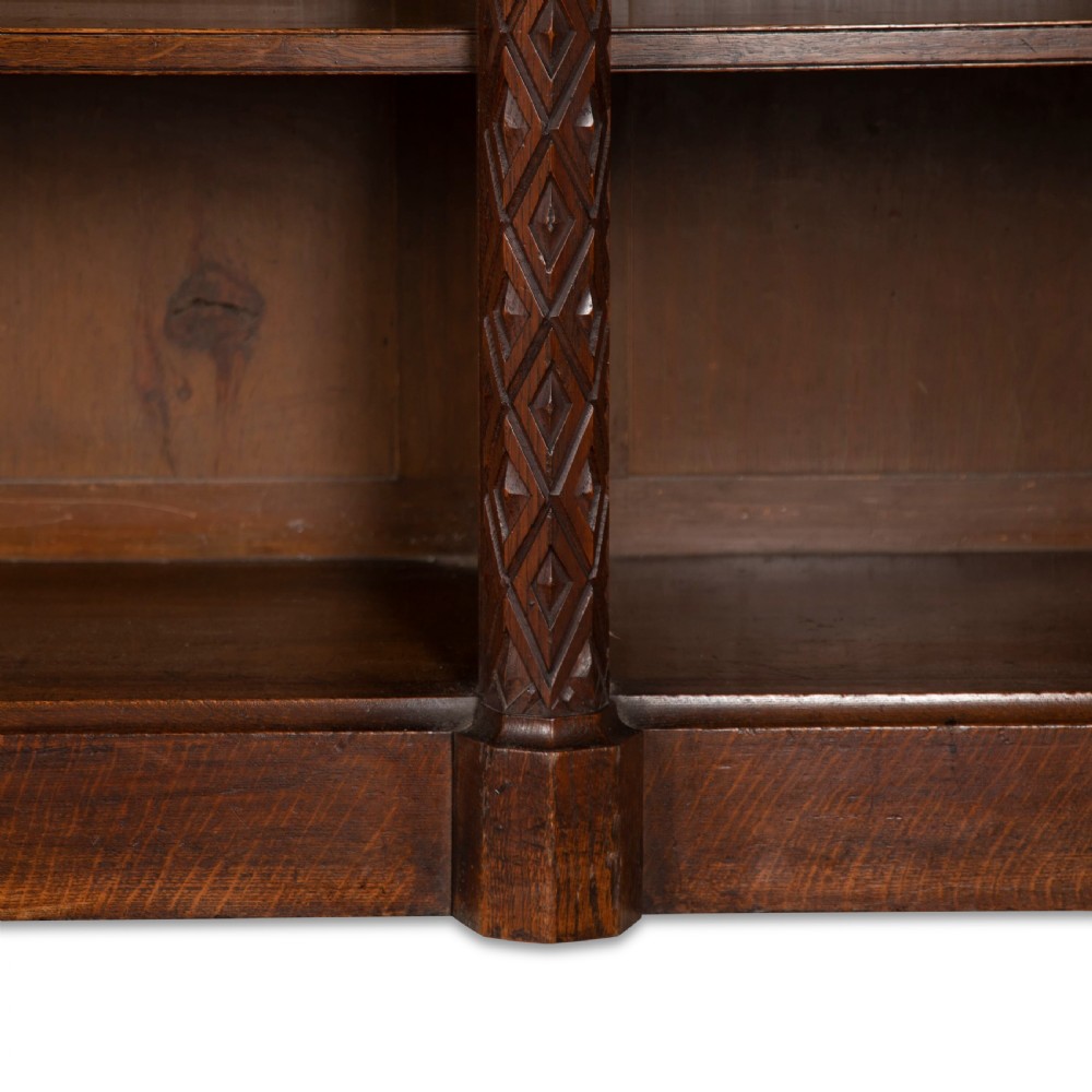 A pair of 19th-century dark wood low open bookcases featuring carved pilasters and open shelves. View XII