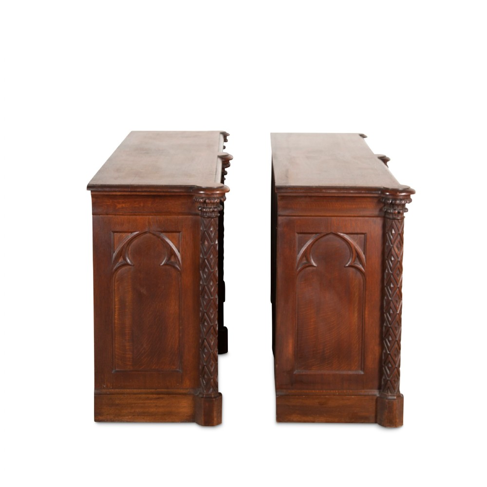 A pair of 19th-century dark wood low open bookcases featuring carved pilasters and open shelves. View XIV
